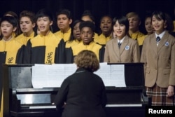 FILE - Choir students from Lincoln High School in Tacoma, Wash., sing with choir students from Tacoma's sister city, Fuzhou, during a performance for Chinese President Xi Jinping during his visit to Tacoma's Lincoln High School, Sept. 23, 2015.