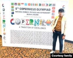 ہیوسٹن میں منعقدہ پانچویں گلوبل کوپرنیکس اولمپیڈ مقابلے میں اول آنے والے پاکستانی طالبعلم سودیس شاہد سٹیفرڈ سنٹر کے باہر جہاں تقسیم ایوارڈ کی تقریب ہوئی اس بورڈ کے ساتھ کھڑے ہیں جس پر مقابلے کے تمام شرکا کے نام تحریر ہیں۔