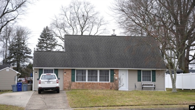 A vehicle is parked in the driveway of a home that was a scene of a murder in Levittown, Pa., on Jan. 31, 2024.