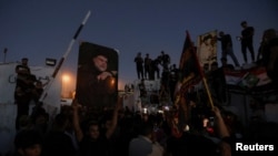 Protesters gather near the Swedish Embassy in Baghdad, Iraq, hours after the compound was stormed ahead of an expected Quran burning in Stockholm, July 20, 2023.