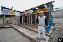 Yukinaga Suzuki, an inn keeper, speaks at his beach house he also runs at the Usuiso beach in Iwaki, northeastern Japan, July 6, 2023.