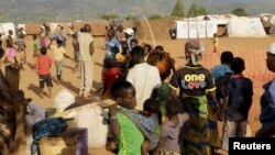 FILE - Refugees wait for registration at Kapise camp in Malawi's Mwanza district, Jan. 18, 2016. 