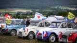 Cars are parked, lined up in a field during the 24th World meeting of Citroen 2CV friends near Delemont, northern Switzerland, July 26, 2023. 