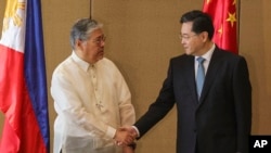 Chinese Foreign Minister Qin Gang, right, and Philippine Foreign Affairs Secretary Enrique Manalo shake hands during the welcome ceremony prior to their bilateral meeting at the Diamond Hotel on April 22, 2023, in Manila, Philippines.