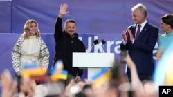 Ukraine's President Volodymyr Zelenskyy, second left, and Lithuania's President Gitanas Nauseda, second right, address the public during an event on the sidelines of a NATO summit in Vilnius, Lithuania, July 11, 2023.