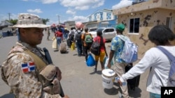 Dominican Republic security forces stand guard on a border bridge between Dajabón, Dominican Republic, and Haiti, Sept. 14, 2023.