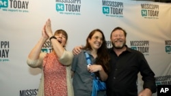 FILE - Mississippi Today reporter Anna Wolfe, center, celebrates winning the 2023 Pulitzer Prize for Local Reporting, accompanied by her mother, Bethel Wolfe, left, and father, Chris Wolfe, in Jackson, May 8, 2023.