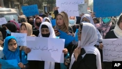 FILE - Afghan women protest during a demonstration in Kabul, Afghanistan, March 26, 2022. The U.N. said April 5, 2023, it cannot accept a Taliban decision to bar Afghan female staffers from working at the agency.