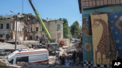 Rescue workers clear the rubble at the site of Okhmatdyt children's hospital hit by Russian missiles in Kyiv, Ukraine, July 9, 2024.