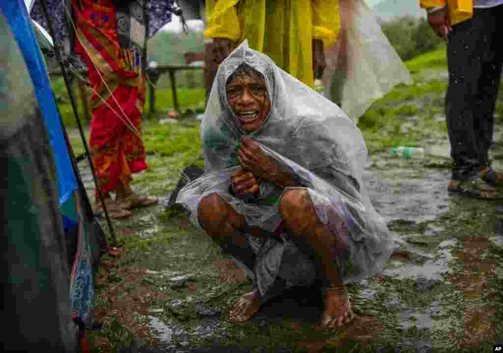 A woman wails after her family members are trapped under rubble from a landslide that washed away houses in the Raigad district, western Maharashtra state, India.