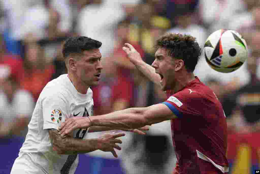 Serbia&#39;s Dusan Vlahovic, right, and Slovenia&#39;s Erik Janza vie for the ball during a Group C match between Slovenia and Serbia at the Euro 2024 soccer tournament in Munich, Germany.