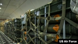 Pallets of ammunition, bound for Ukraine, are secured inside a commercial aircraft during a security assistance mission at Dover Air Force Base, Delaware, Jan. 13, 2023. 