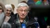 Oleg Orlov, the 70-year-old human rights campaigner and co-chair of the Nobel Prize winning Memorial group, who is charged with 'discrediting' the Russian army, talks to the media and his supporters outside a court building in Moscow, Feb. 26, 2024. 