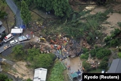 An aerial view shows rescue workers conducting search and rescue operation at a landslide site caused by a heavy rain due to the approach of Typhoon Shanshan in Gamagori, Aichi Prefecture, central Japan, Aug. 28, 2024, in this photo taken by Kyodo.