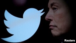 FILE - Twitter logo and a photo of Elon Musk are displayed through magnifier in this illustration taken Oct. 27, 2022. Musk said, July 23, 2023 that he was looking to change Twitter's logo.