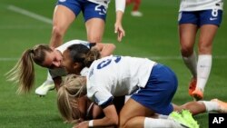 England's Lauren James, center, is congratulated by teammates England's Ella Toone and England's Rachel Daly after scoring the opening goal during the Women's World Cup Group D soccer match between England and Denmark at Sydney Football Stadium in Sydney.