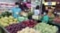 FILE - People buy fruit at a stall in Taipei, Taiwan, Sept. 20, 2021. 