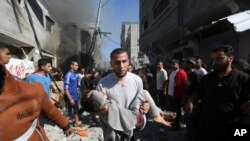 Palestinians rescue survivors after an Israeli strike on Rafah, Gaza Strip, Nov. 17, 2023.