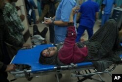 Palestinians wounded in the Israeli bombardment of the Gaza Strip are brought to the hospital in Deir al Balah, Dec. 3, 2023.