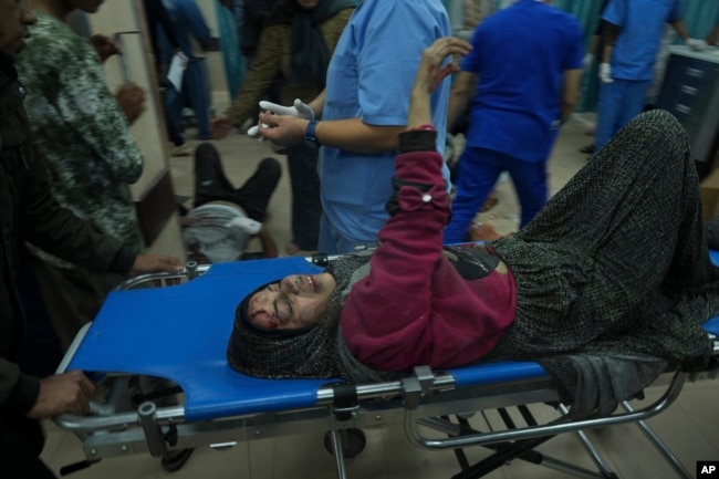 Palestinians wounded in the Israeli bombardment of the Gaza Strip are brought to the hospital in Deir al Balah, Dec. 3, 2023.