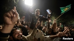 Supporters of Former Prime Minister of Pakistan Nawaz Sharif cheer as they gather at the party office of Pakistan Muslim League, at Model Town in Lahore, Pakistan, Feb. 9, 2024.