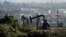 FILE - Active pumpjacks from oil wells are pictured at the Inglewood Oil Field, the largest urban oil field in the United States, from the Baldwin Hills Scenic Overlook in Culver City, California, March 10, 2022. 