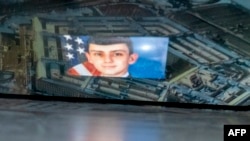 FILE - This photo illustration created April 13, 2023, shows the suspected intelligence leaker, Air National Guardsman Jack Teixeira, reflected in an image of the Pentagon in Arlington, Virginia.