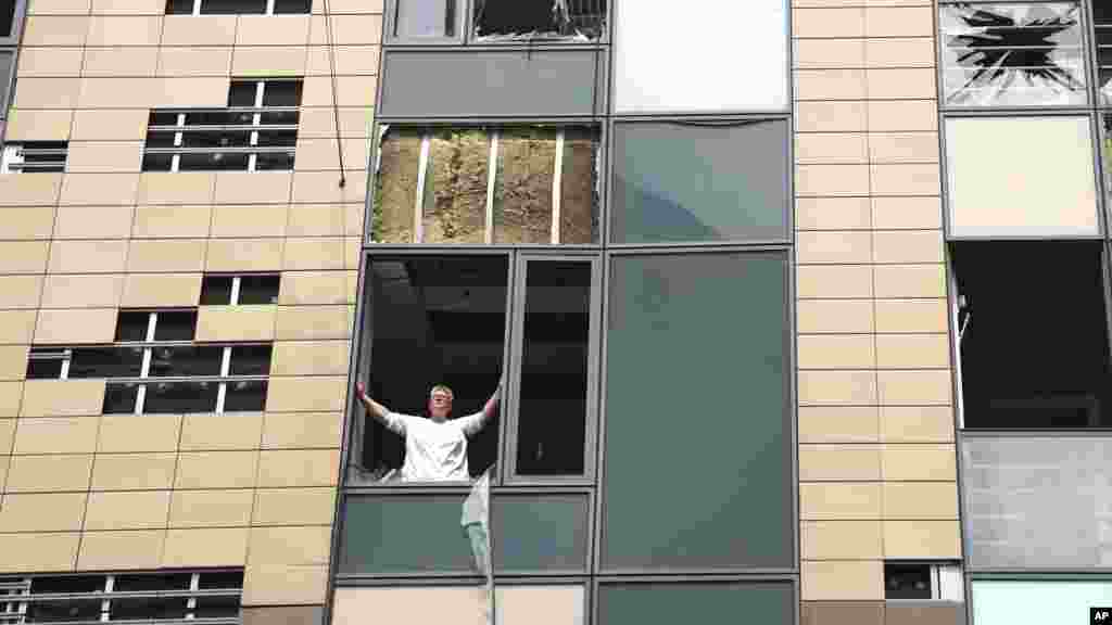 A medical worker looks out from a damaged window after Russian missile hit the country&#39;s main children hospital Okhmatdyt in Kyiv, Ukraine, July 8, 2024.