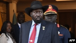 FILE - South Sudan's President Salva Kiir, center, stands at the Presidential Palace in Juba, South Sudan, on Feb. 3, 2023.