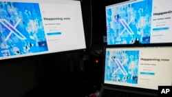 A view of a lap top and monitors showing the Twitter signing in page displaying the new logo, in Belgrade, Serbia, Monday, July 24, 2023. (AP Photo/Darko Vojinovic)