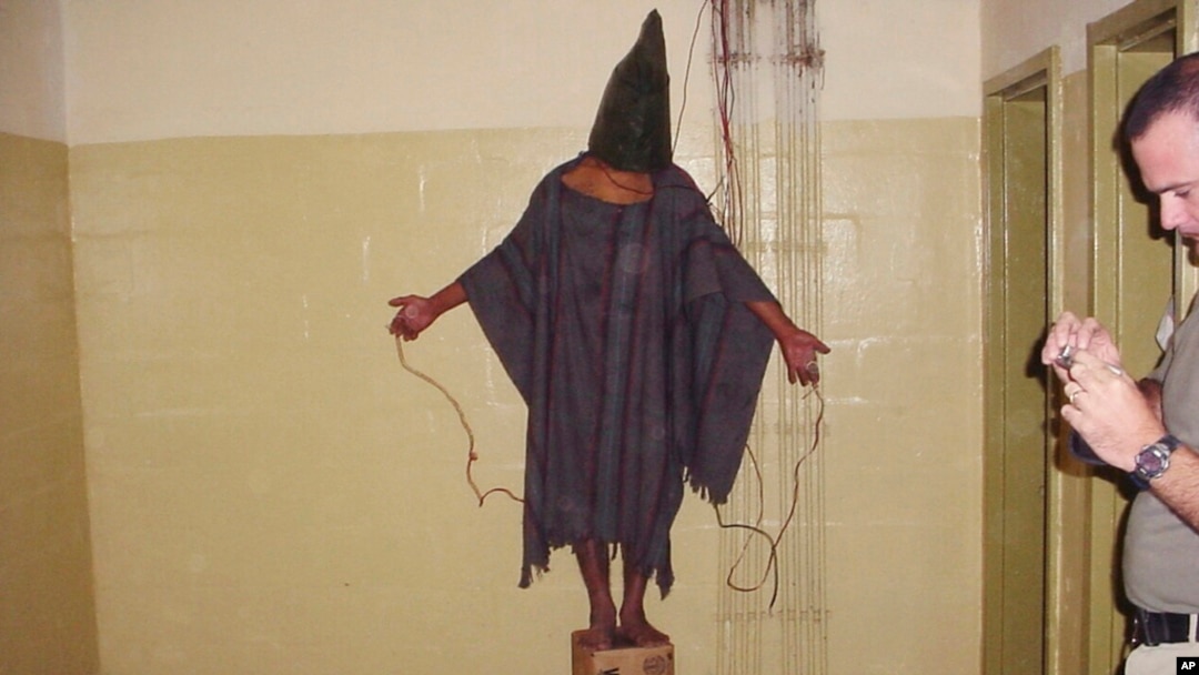 FILE - This late 2003 photo obtained by The Associated Press shows an unidentified detainee standing on a box with a bag on his head and wires attached to him in the Abu Ghraib prison in Baghdad, Iraq.