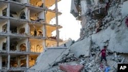 Palestinians inspect the damage after an Israeli bombardment on east of Deir al-Balah, Aug. 29, 2024. 