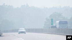 Commuters drive in haze from Canadian wildfires on Interstate 76 near Hershey, Pa., June 29, 2023.