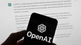 The OpenAI logo is seen on a mobile phone in front of a computer screen which displays output from ChatGPT, March 21, 2023, in Boston.(AP Photo/Michael Dwyer, File)