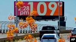 A digital billboard displays the temperature in Fahrenheit July 17, 2023, in downtown Phoenix. In Celsius, it's almost 43 degrees.