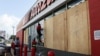 Workers board up a business to avoid damage ahead of Hurricane Beryl, in Merida, Mexico, July 3, 2024. 