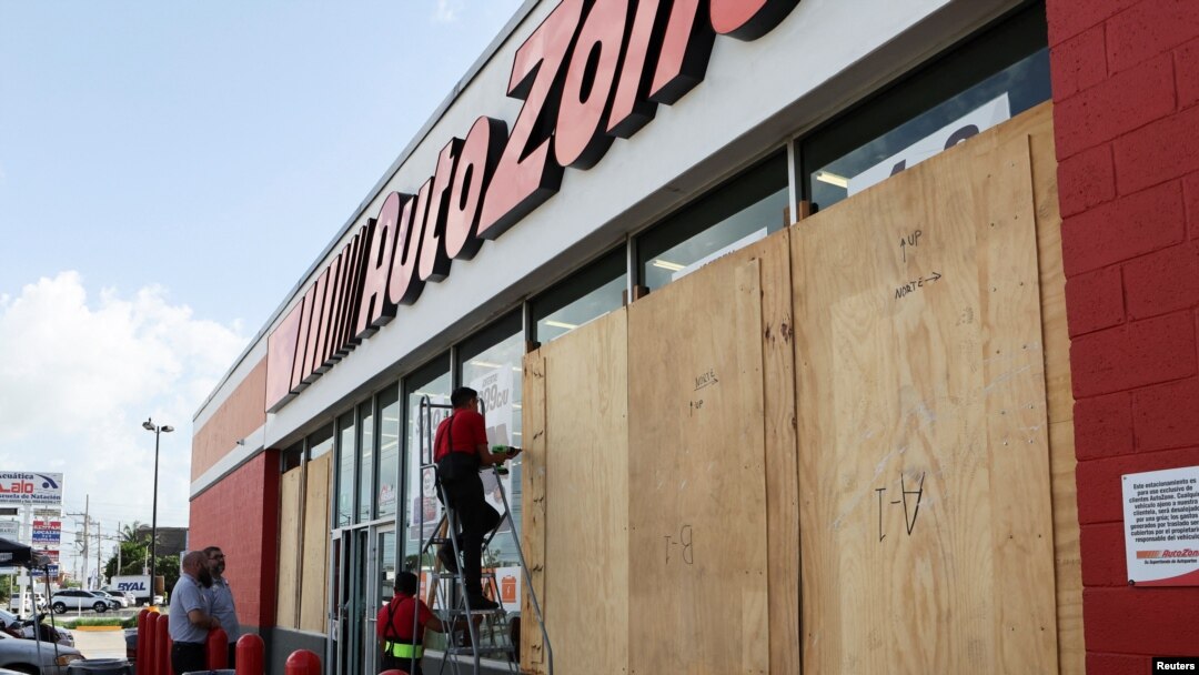 Workers board up a business to avoid damage ahead of Hurricane Beryl, in Merida, Mexico, July 3, 2024.
