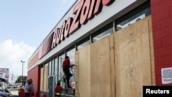 Workers board up a business to avoid damage ahead of Hurricane Beryl, in Merida, Mexico, July 3, 2024.