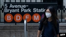 Commuters wear masks during the morning rush hour June 8, 2023, in New York City, as smoke from wildfires in Canada continue to affect the city.