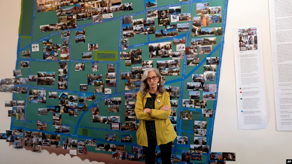 Judy Branfman stands by a map she created as part of a gallery installation at Beyond Baroque Gallery on Nov. 3, 2023, in the Venice Beach area of Los Angeles. (AP Photo/Richard Vogel)