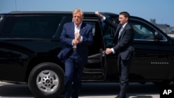 FILE - Former President Donald Trump arrives to board his airplane for a trip to a campaign rally in Waco, Texas, at West Palm Beach International Airport, March 25, 2023, in West Palm Beach, Fla.