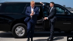 FILE - Former President Donald Trump arrives to board his airplane for a trip to a campaign rally in Waco, Texas, at West Palm Beach International Airport, March 25, 2023, in West Palm Beach, Fla.