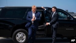 FILE - Former President Donald Trump arrives to board his airplane for a trip to a campaign rally in Waco, Texas, at West Palm Beach International Airport, March 25, 2023, in West Palm Beach, Fla.