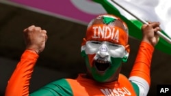 An Indian supporter cheers for his team ahead of the ICC Men's T20 World Cup cricket match between Afghanistan and India at Kensington Oval in Bridgetown, Barbados, June 20, 2024.