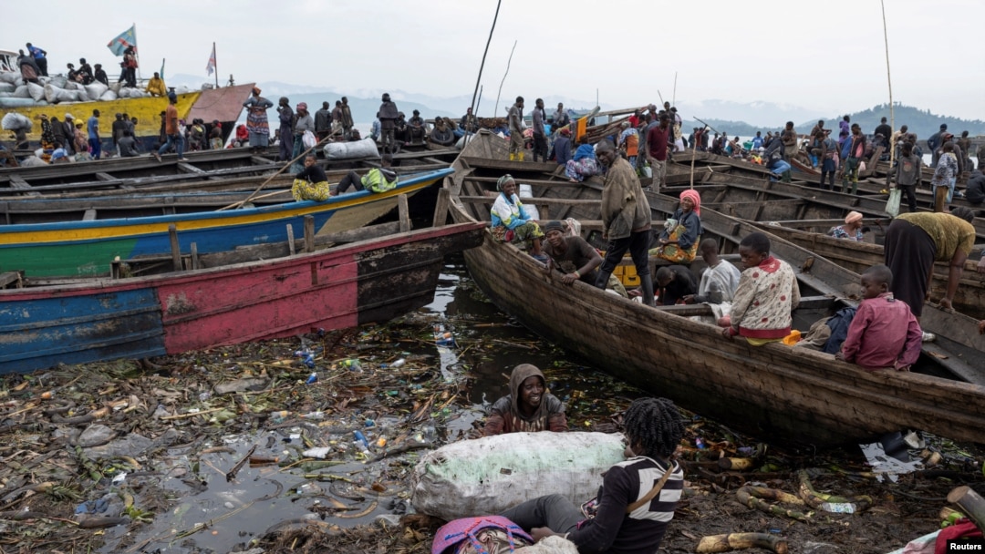 Congolese traders offload goods from Minova village, after the roads were blocked due to the ongoing war between the M23 rebels and the Congolese army, at the Kituku market in Goma, North Kivu province of the Democratic Republic of Congo, Feb. 15, 2024. 