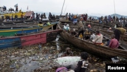 Congolese traders offload goods from Minova village, after the roads were blocked due to the ongoing war between the M23 rebels and the Congolese army, at the Kituku market in Goma, North Kivu province of the Democratic Republic of Congo, Feb. 15, 2024. 