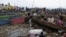 Congolese traders offload goods from Minova village, after the roads were blocked due to the ongoing war between the M23 rebels and the Congolese army, at the Kituku market in Goma, North Kivu province of the Democratic Republic of Congo, Feb. 15, 2024. 