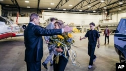 In this photo provided by the Swedish government, Saeed Azizi reunites with his family at Arlanda airport in Stockholm on June 15, 2024, after being released from prison in Iran.