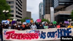 Protesters rally at Legislative Plaza near the Tennessee State Capitol building to urge Governor Bill Lee to veto proposed anti-immigration bills in Nashville, Tennessee, April 4, 2024.