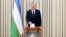 In this handout photo released by Uzbekistan's Presidential Press Office, Uzbekistan's President Shavkat Mirziyoyev casts his ballot at a polling station during a snap presidential election in Tashkent, Uzbekistan, July 9, 2023. 